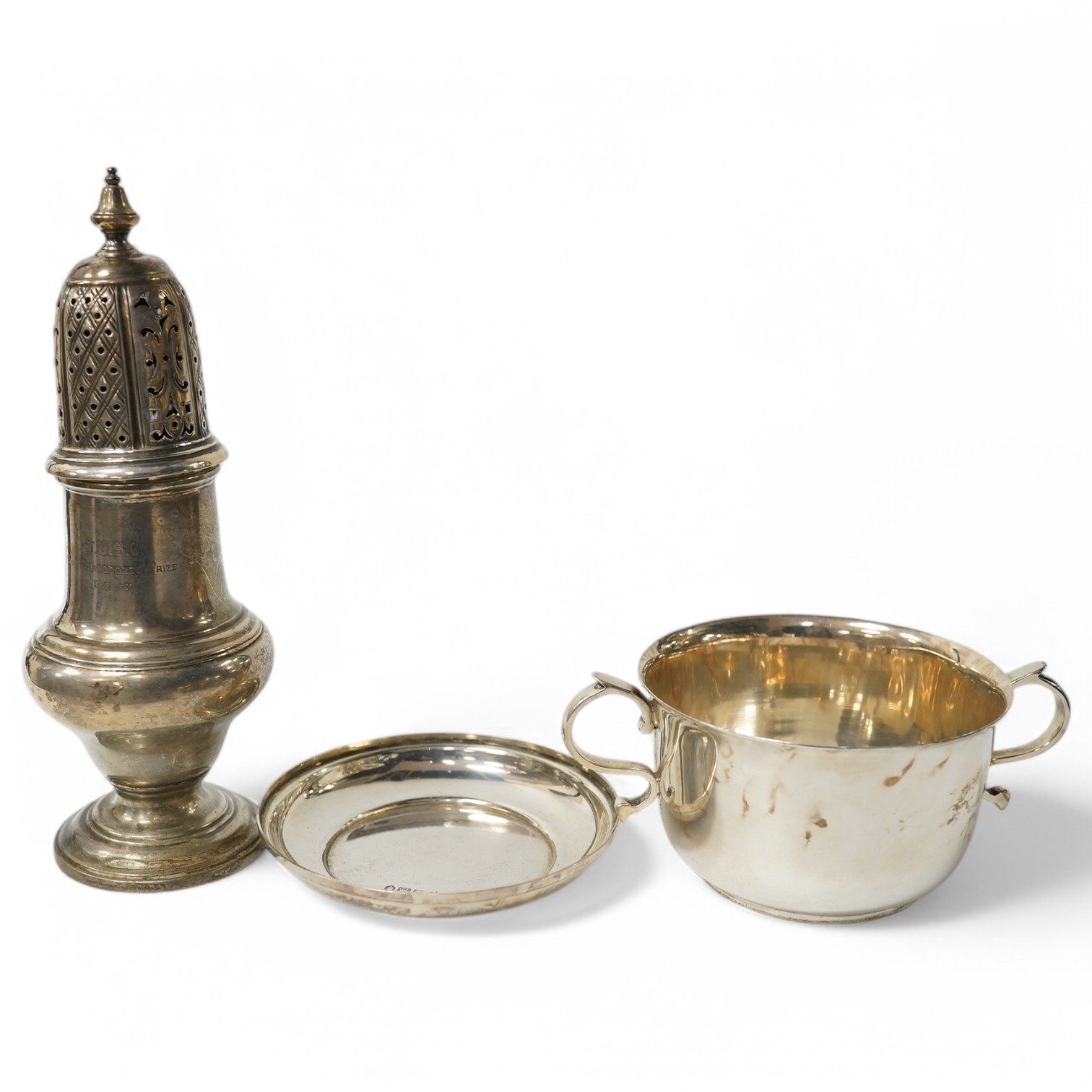 An Edwardian silver two handled silver porringer on stand, S.W. Smith & Co, London, 1904 and a late Victorian silver sugar caster, London, 1898, 12.7oz. Condition - fair to good